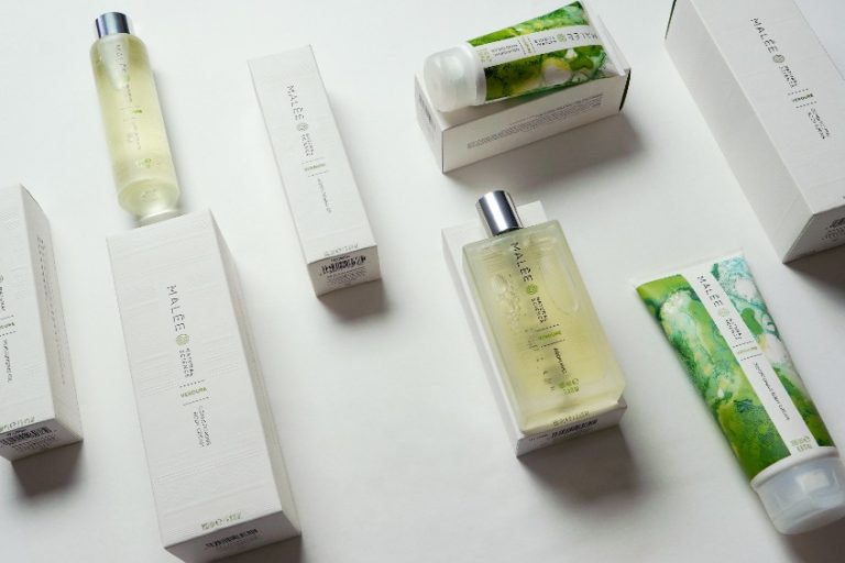 Christmas Gift For Her Malee Natural Science On a white platform Malee 100ml Body oil, Verdure 100ml Room Mist, 75ml Nourishing Hand cream and 200ml Conditioning Body Cream are set up.