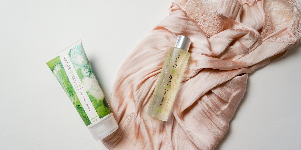 Body-Care-in-5-Easy-Steps-Malee-Natural-Science Body Care in 5 Easy Steps On a dusty pink dressing gown, a 100ml Moisturising Body oil, next to it a 200ml Verdure Conditioning Body Cream