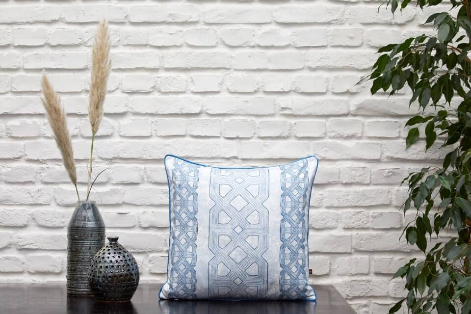 Malée Natural Science Interior design Eva Sonaike Ala indigo cushion on console table with vases and green plant