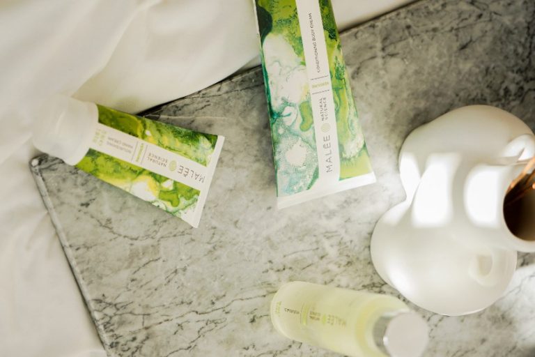 How to get glowing skin Malee Natural Science A marbled tray is set on a white linen, with a white porcelain flower pot Verdure 100ml Moisturising Body Oil, 75ml Nourishing Hand Cream and 200ml Verdure Conditioning Body Cream