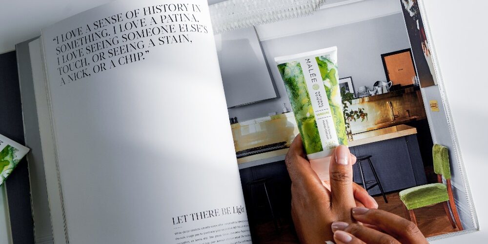 Dry Skin-a-concise-guide-Malee-Natural-Science Dry Skin A concise guide Malee Natural Science, on an opened magazine page, a female hands holding the Verdure 75ml Nourishing Hand Cream