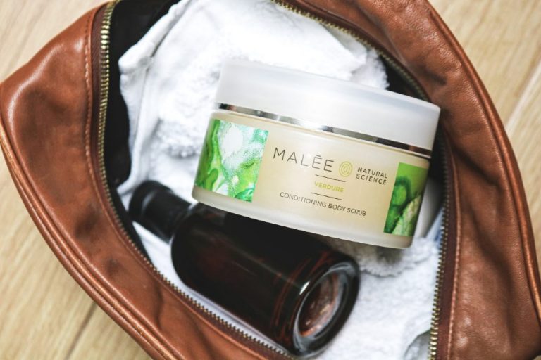Men's Luxury Skincare Malee Natural Science Verdure Conditioning Scrub with white towel and an amber glass bottle in a brown bag