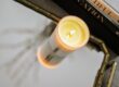 Relax Room placed on a silver and gold plate, a burning Verdure Soy Candle. Aside few books