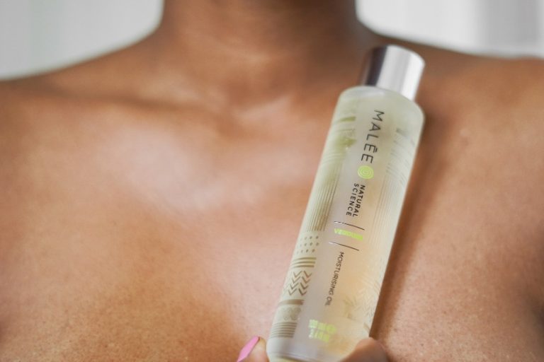 Mental Health Awareness Malee Natural Science A bare-chested African lady holding a Malee 100ml Moisturising body oil Glass bottle