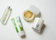 Skincare Ingredients To Avoid Malee natural Science On a white surface, an opened 250ml Malee Moisturising Body scrub, A 100ml Verdure Moisturising Body Oil and a 220ml 100% Verdure Soy Candle